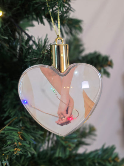 Plastic bauble glowing with colored light - heart