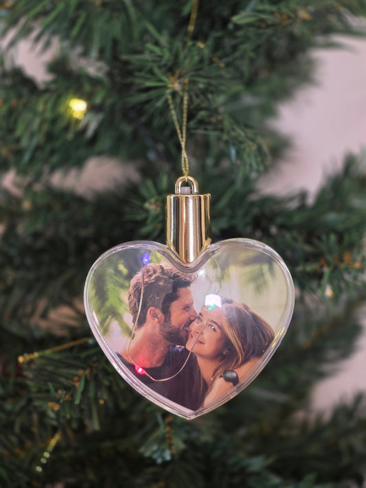 Plastic bauble glowing with colored light - heart