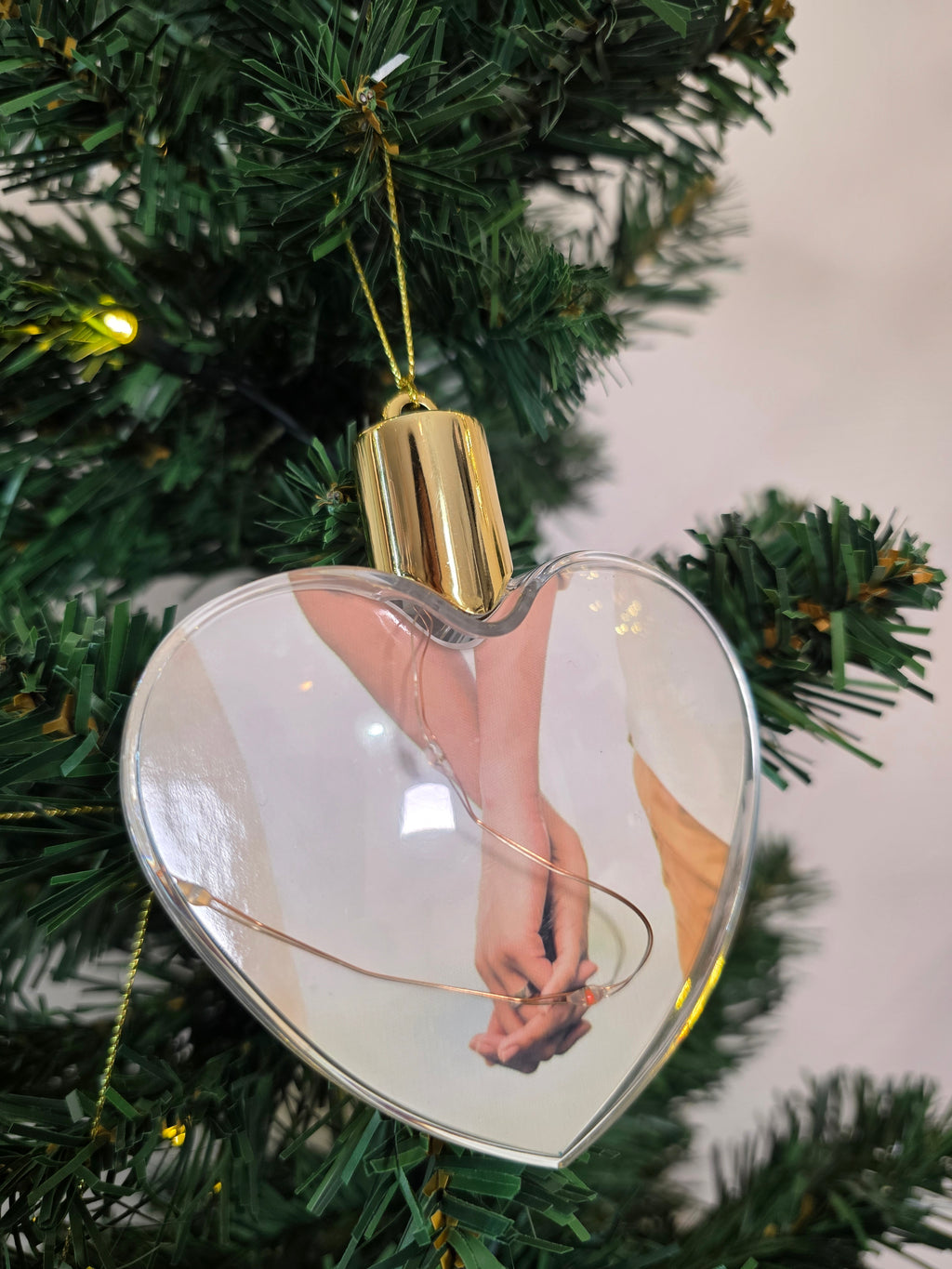 Plastic bauble glowing with colored light - heart