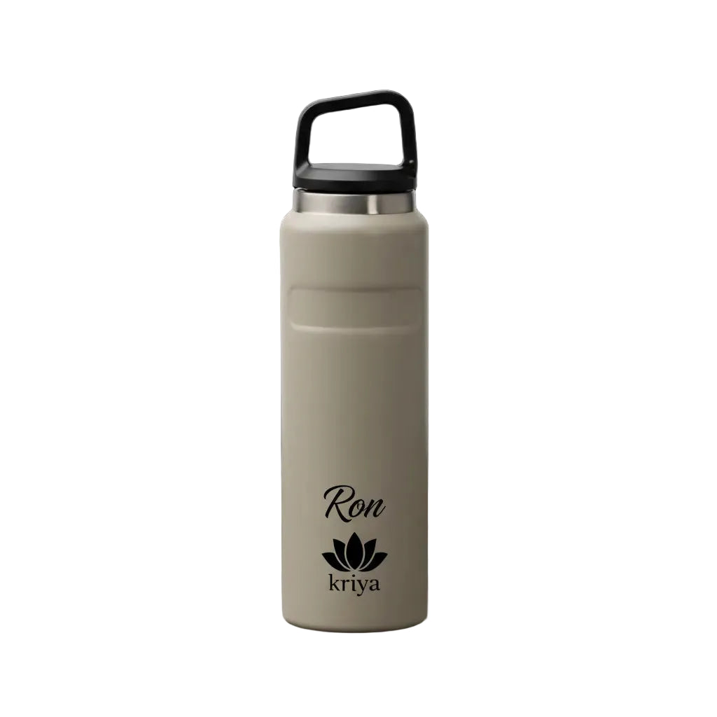 Beige water bottle with black lid on a black background