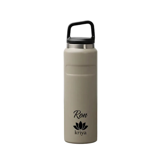 Beige water bottle with black lid on a black background